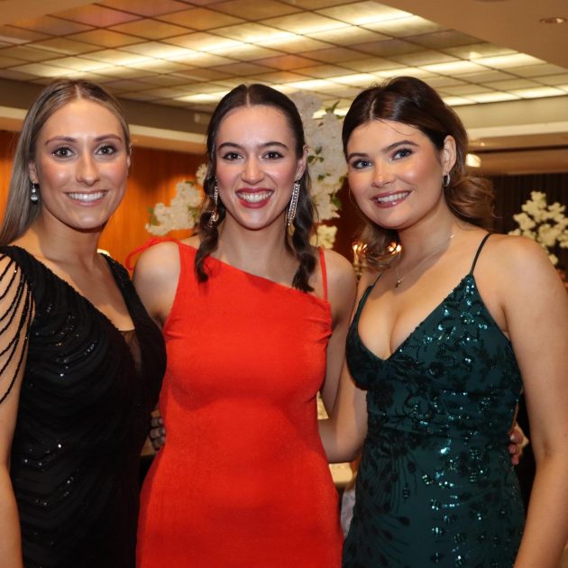 Three women in formal gowns at a gala- We do events