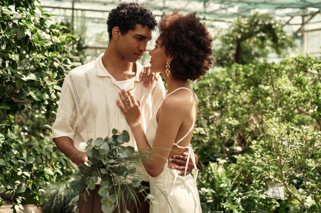 Couple embraces in a lush greenhouse - We do events