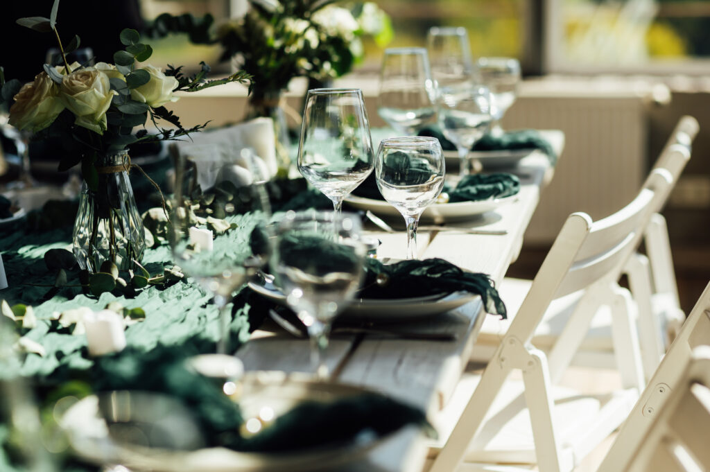Elegant festive table setting with green decor and glassware - We do events