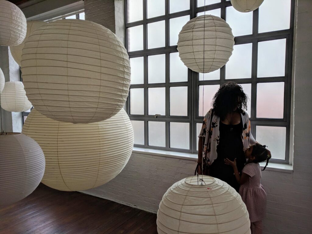 A Woman and child surrounded by Akari lamps - We do events