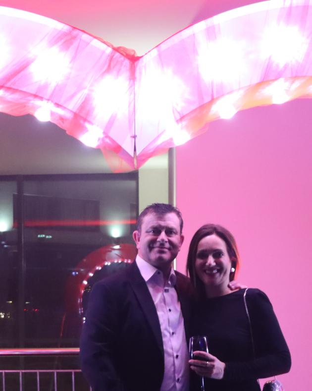 Guests smiling under a light-up heart arch decor feature at a Galway event