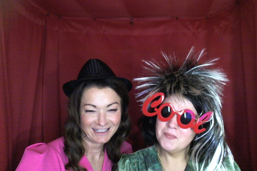 Guests laughing in a photo booth with fun props at a Galway event