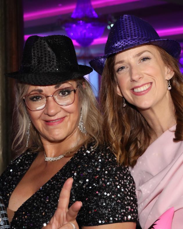 Guests enjoying a styled evening event with photo booth props in Galway