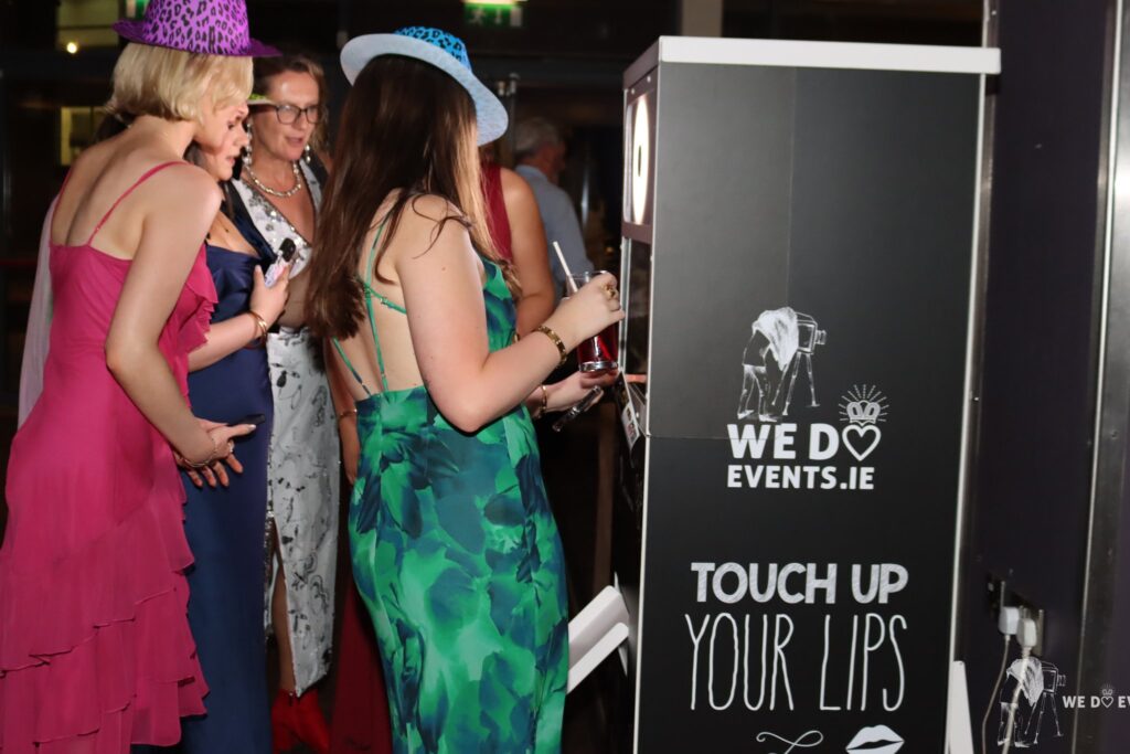 Guests beside the branded We Do Events photo booth at a charity gala in the Galmont Hotel, Galway